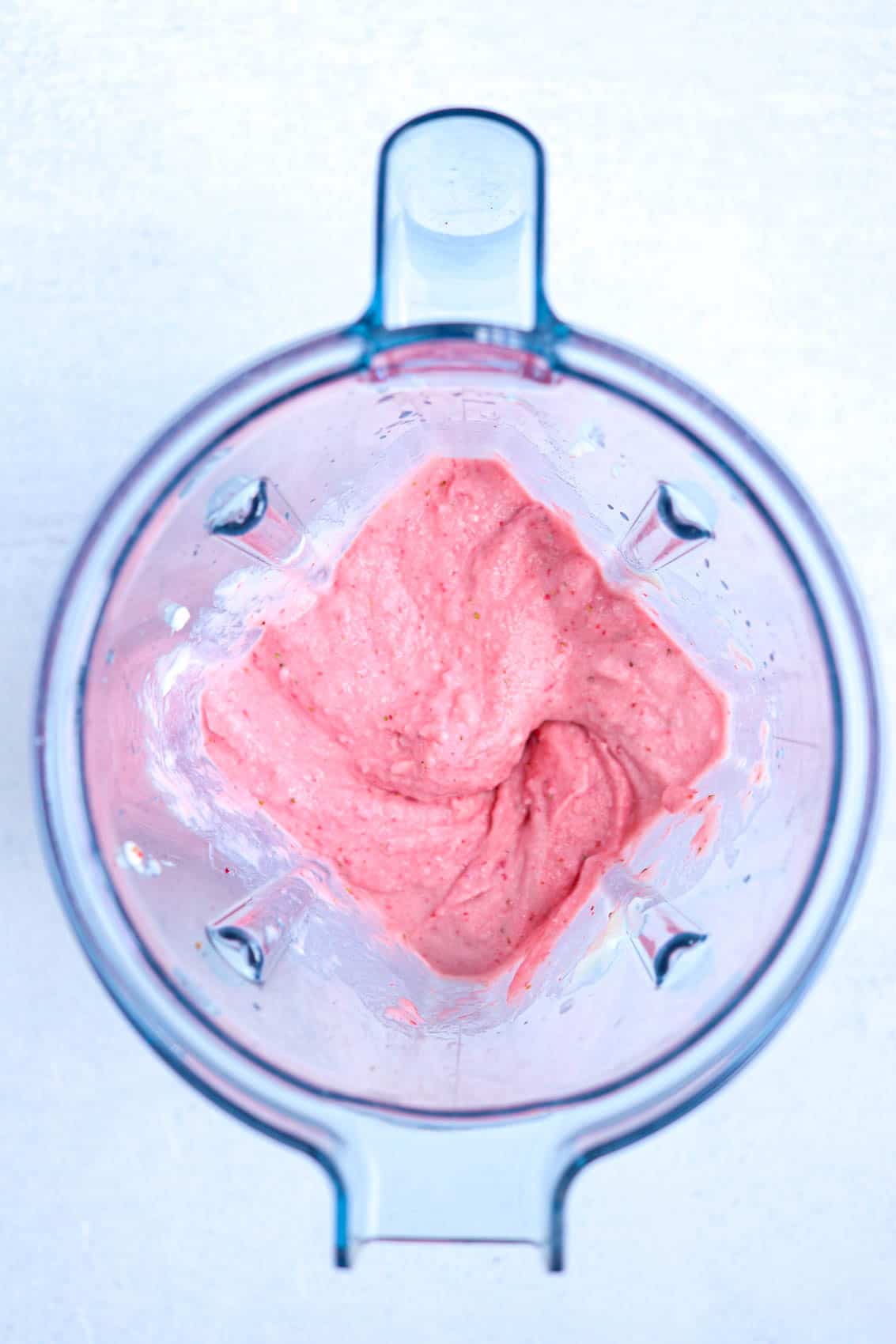 thick strawberry smoothie in a blender.