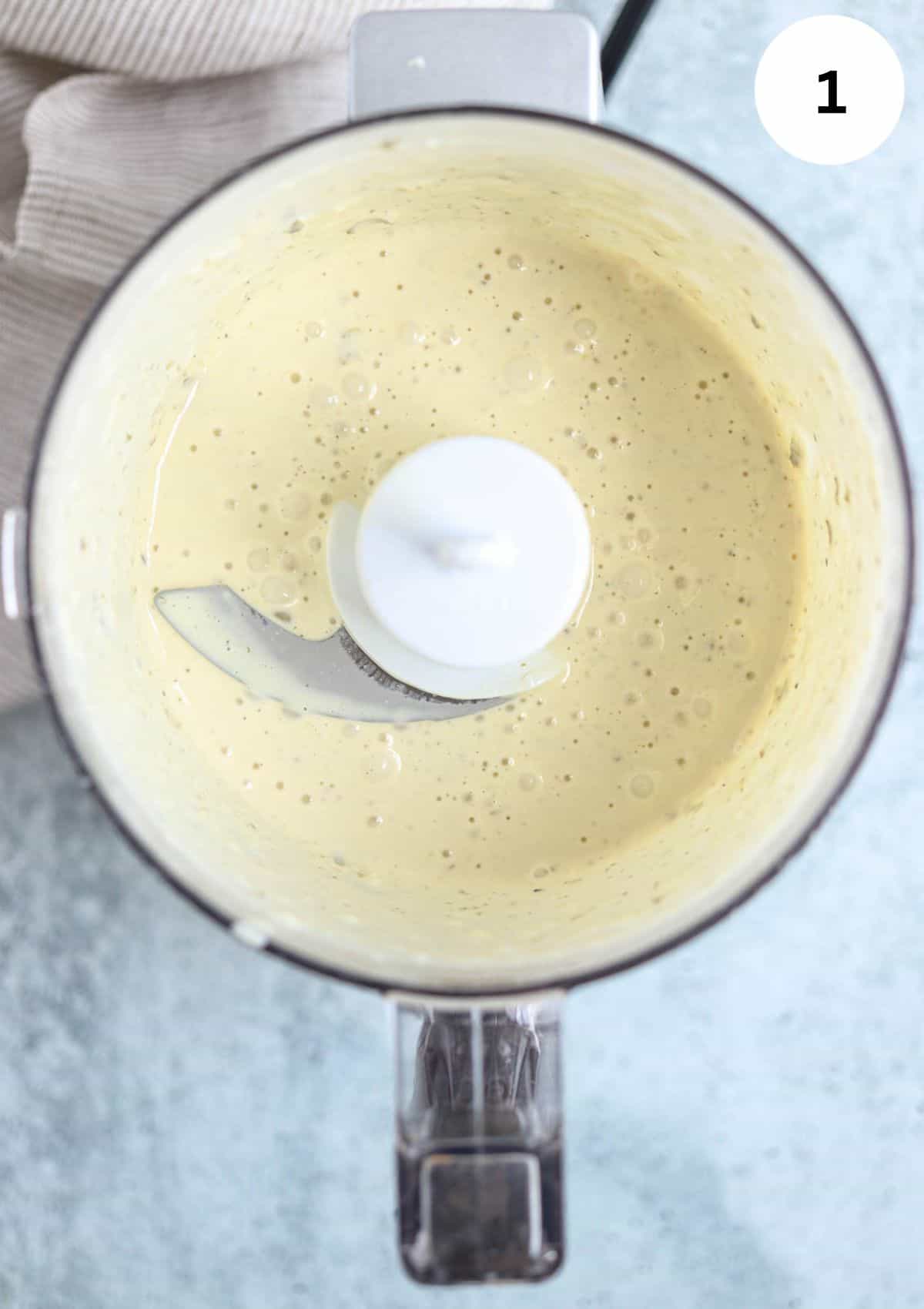 caesar dressing in a small food processor after blending.