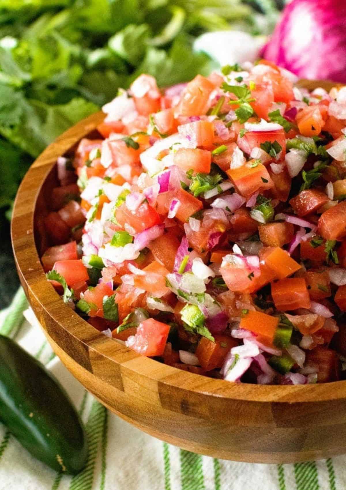 pico de gallo in a wooden bowl.