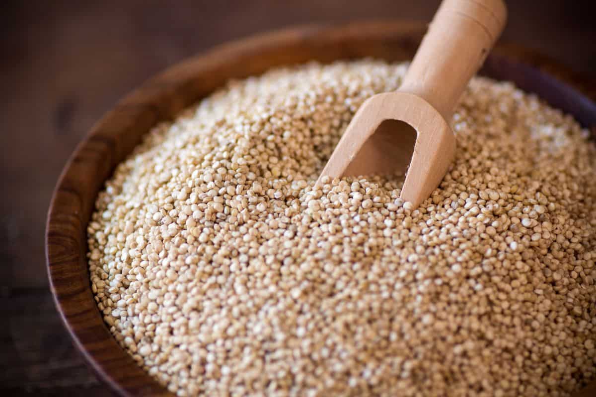uncooked quinoa in a wooden bowl.