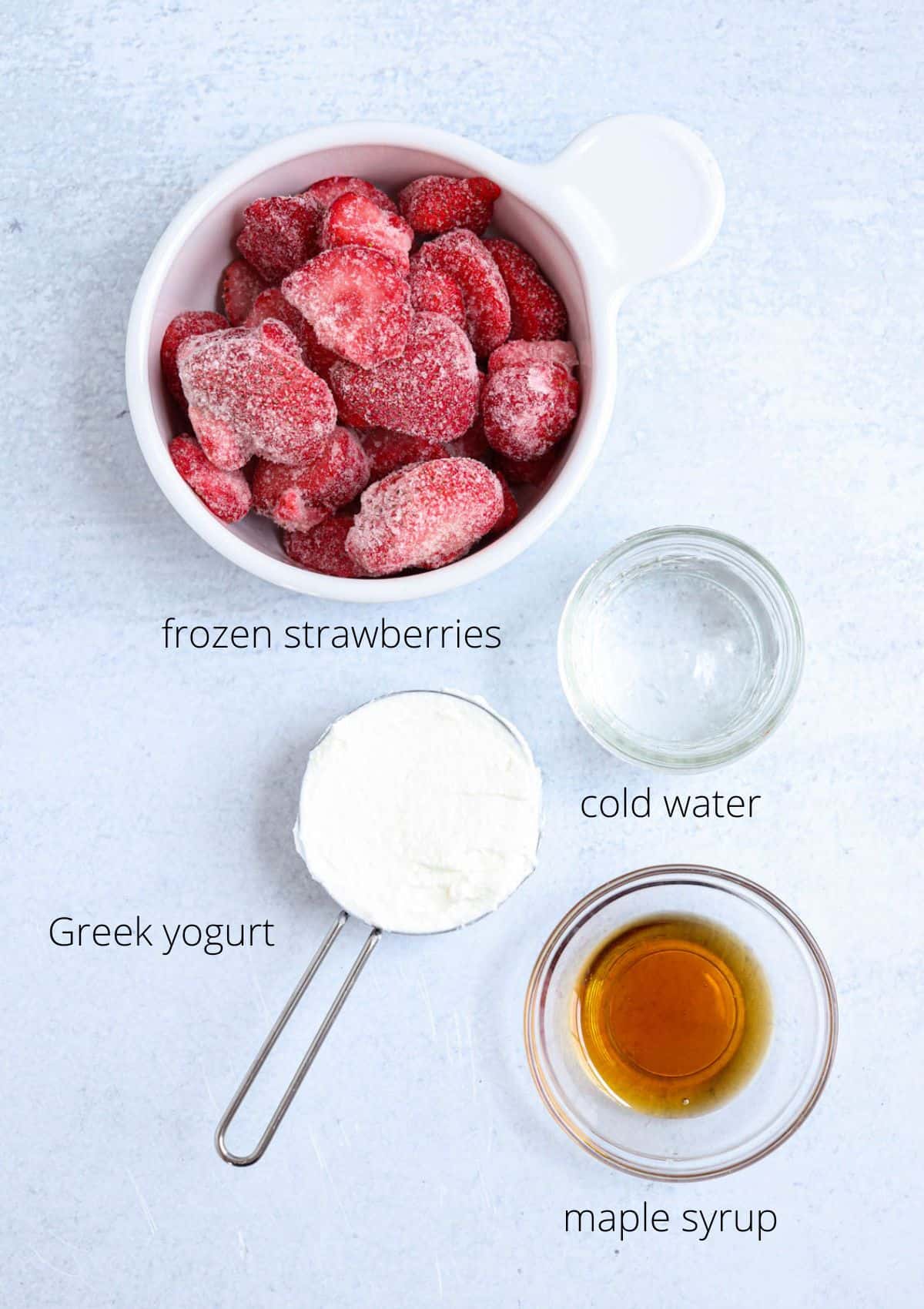 ingredients for making strawberry smoothie bowl on gray surface with captions.
