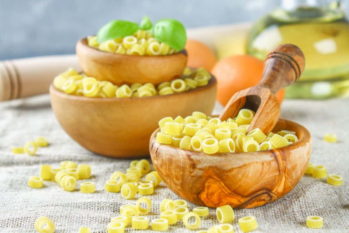 uncooked tubettini pasta in wooden bowls.