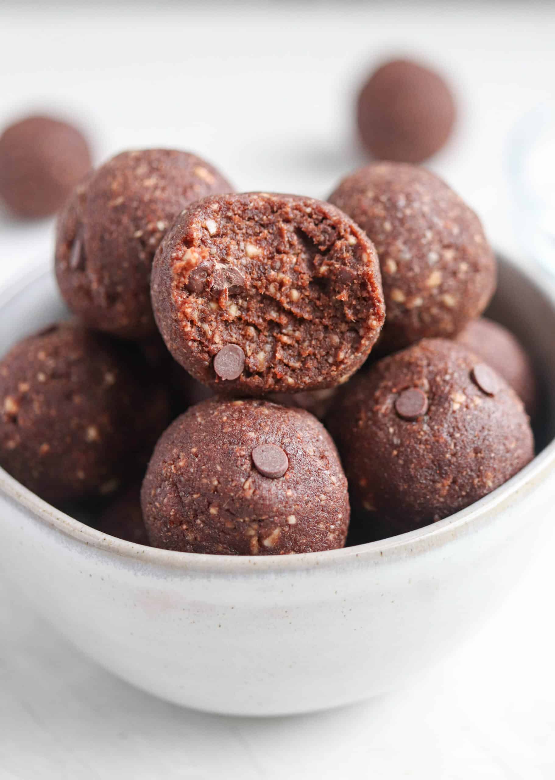 chocolate bliss balls with mini chocolate chips in a bowl. 