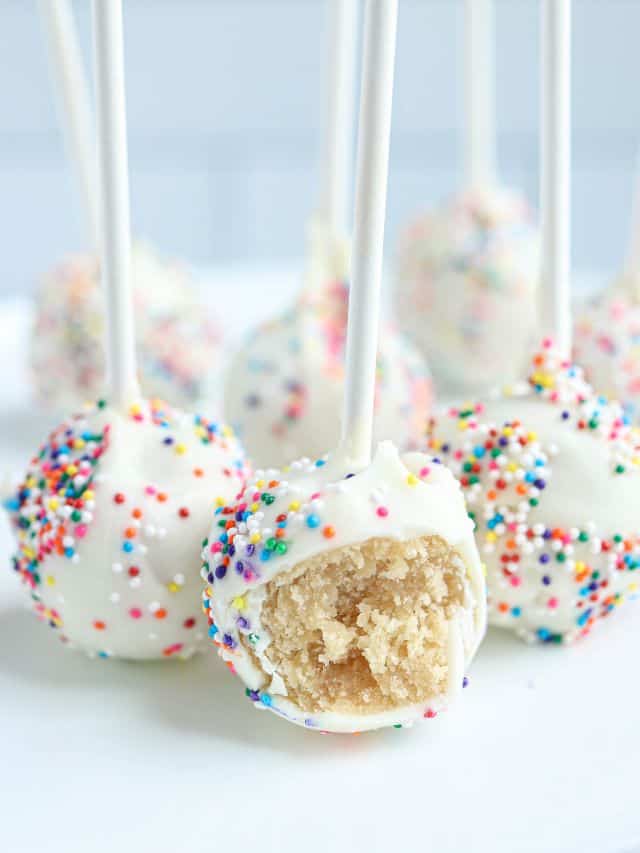 no bake cake pops covered in white chocolate and sprinkles.