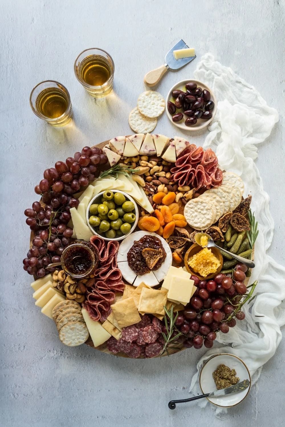 meat and cheese board with grapes.