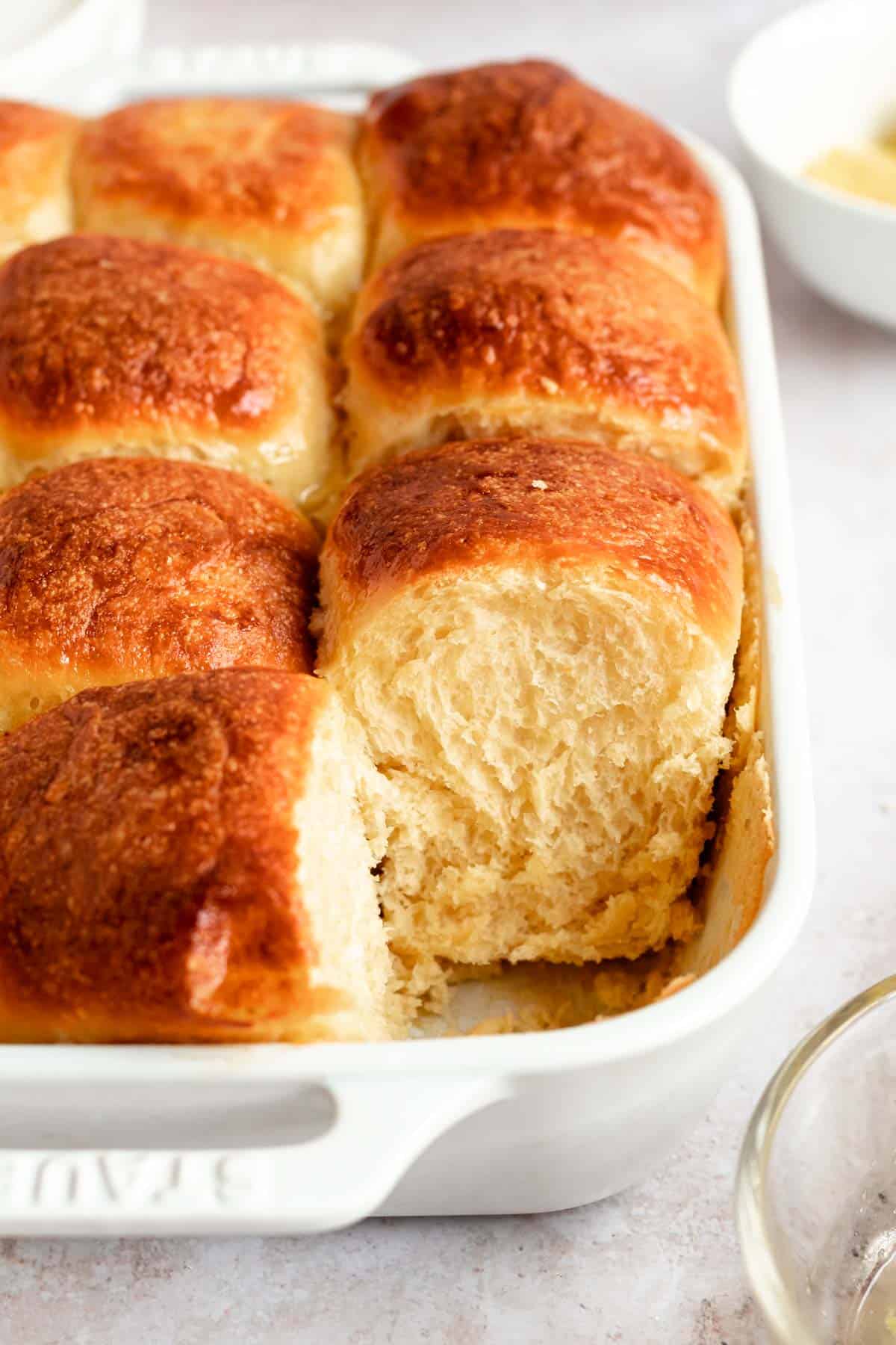 soft brioche rolls in a whire casserole dish.