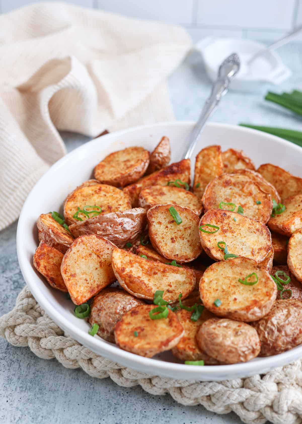 air fried red potato halves in a white serving bowl. 