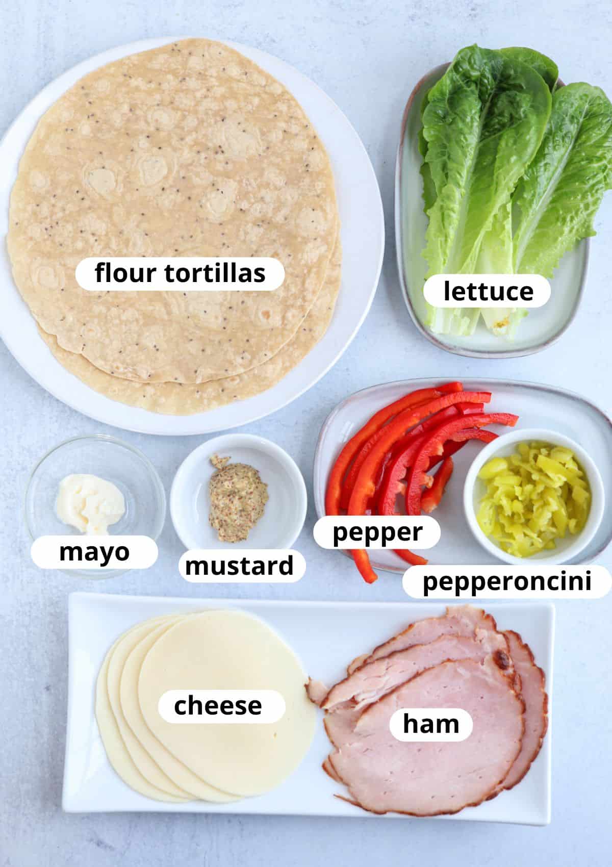 ingredients for making a ham and cheese wrap on light gray background with captions.