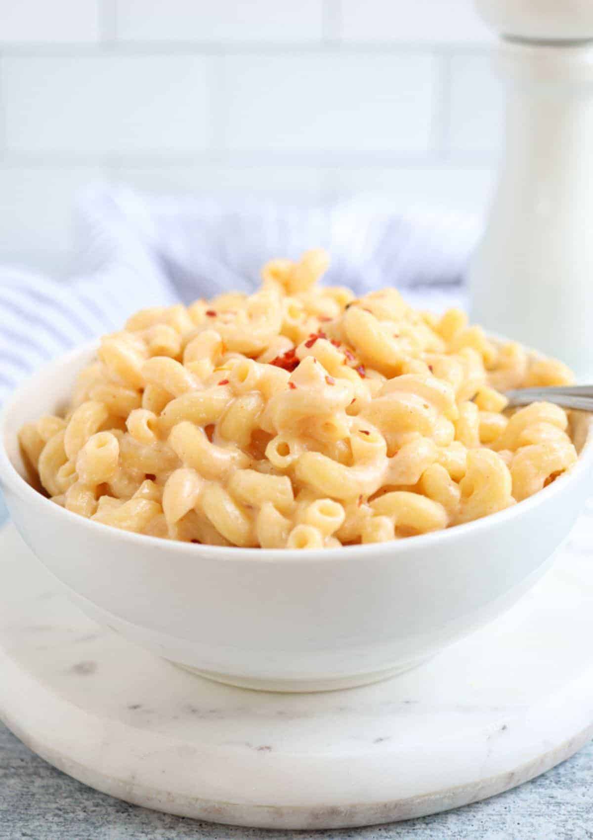 mac and cheese in a white bowl.