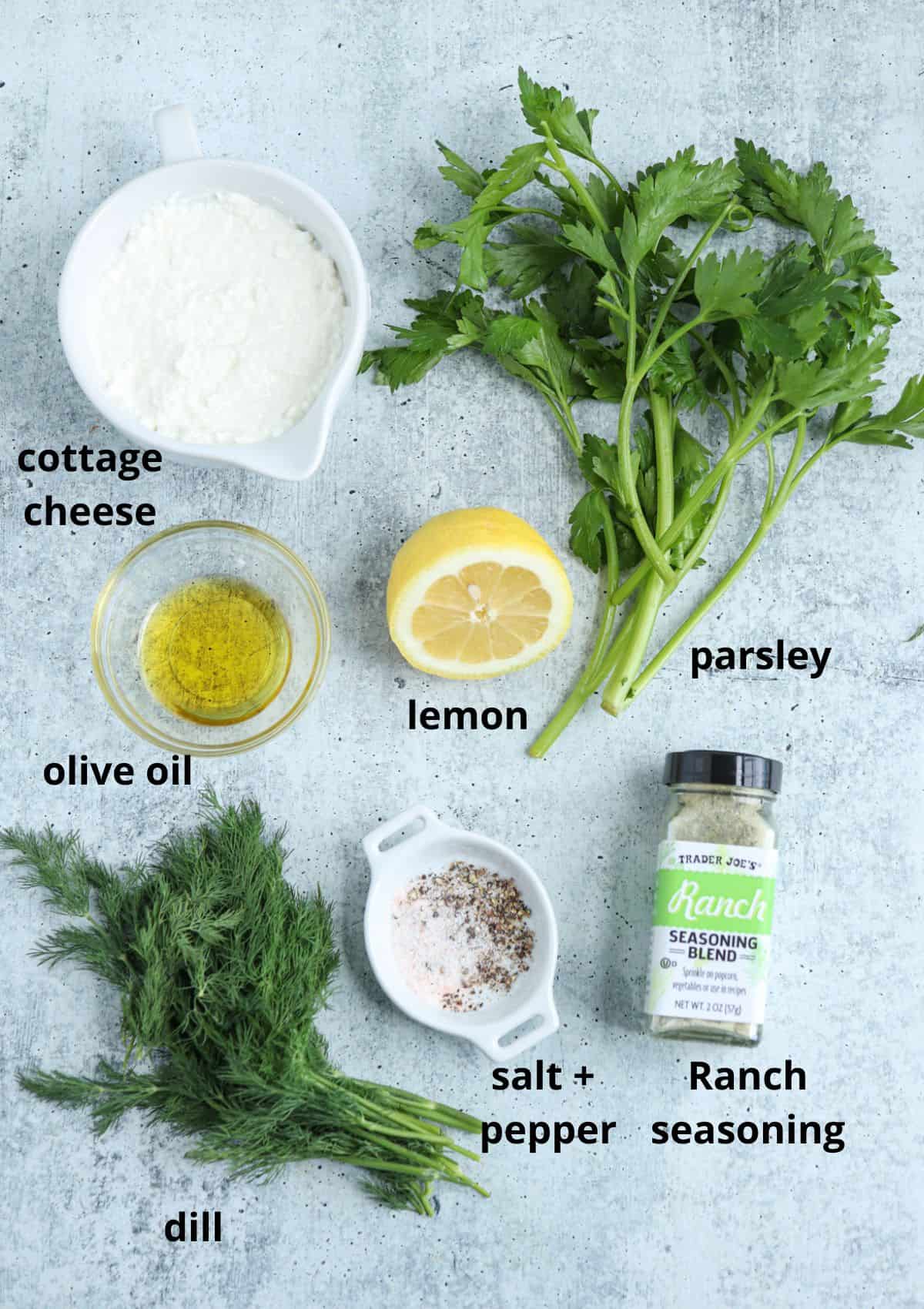 ingredients for makingt ranch cottage cheese dip on gray background with captions.