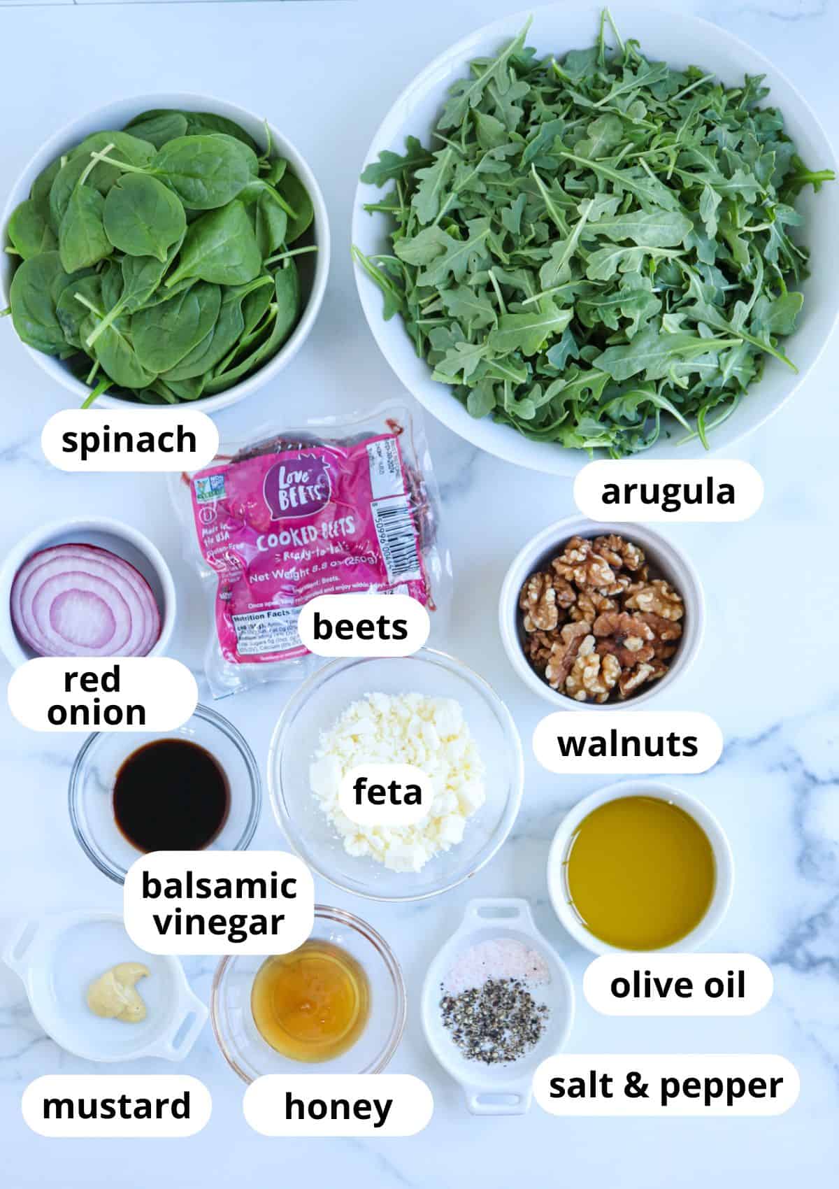 ingredients for making beet salad with feta on white marble background.