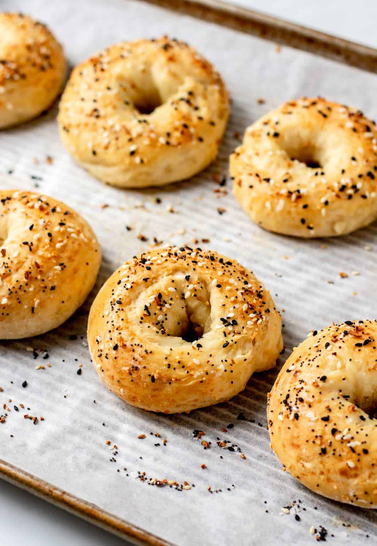 cottage cheese bagels on a paper lined baking tray.