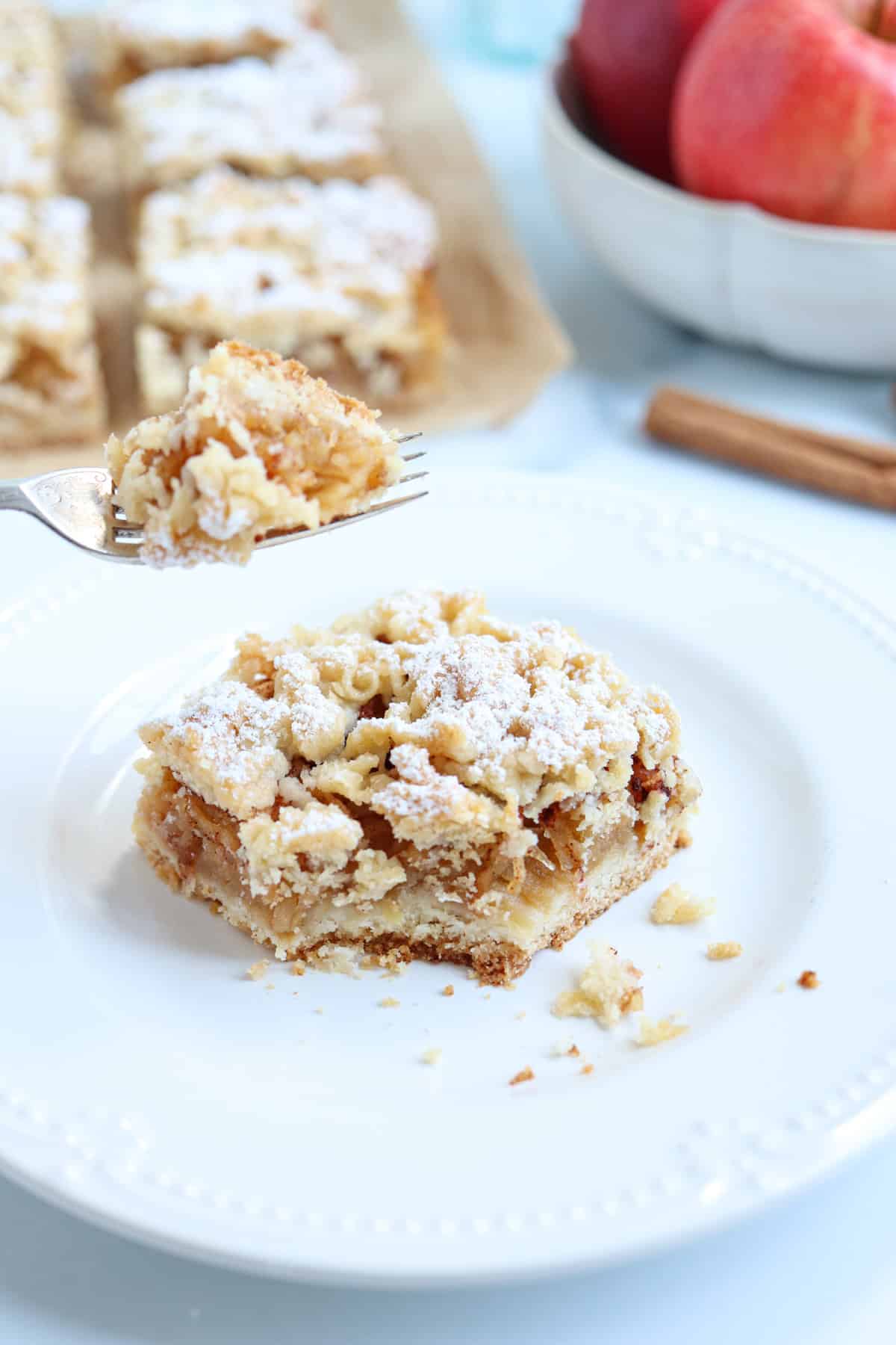 a piece of Polish apple cake on a white plate.