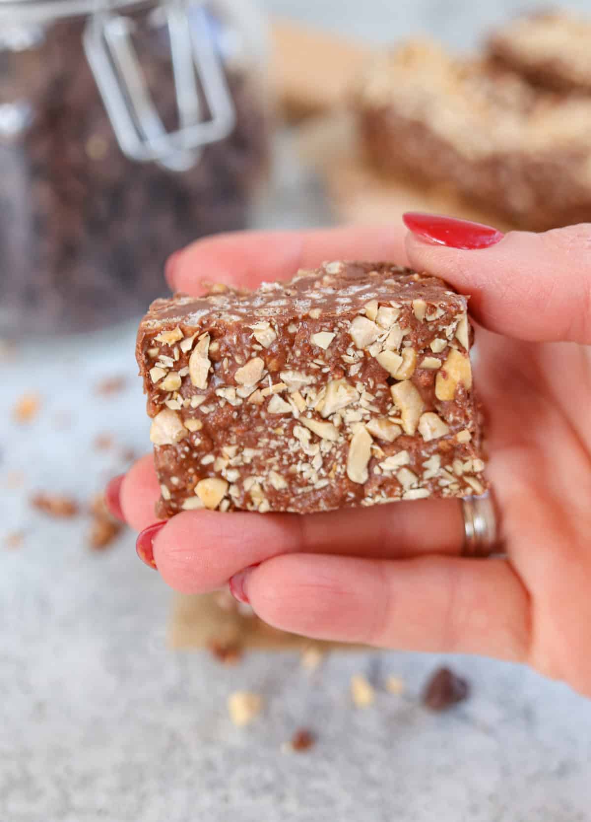 a hand holding one peanut butter chocolate bars.