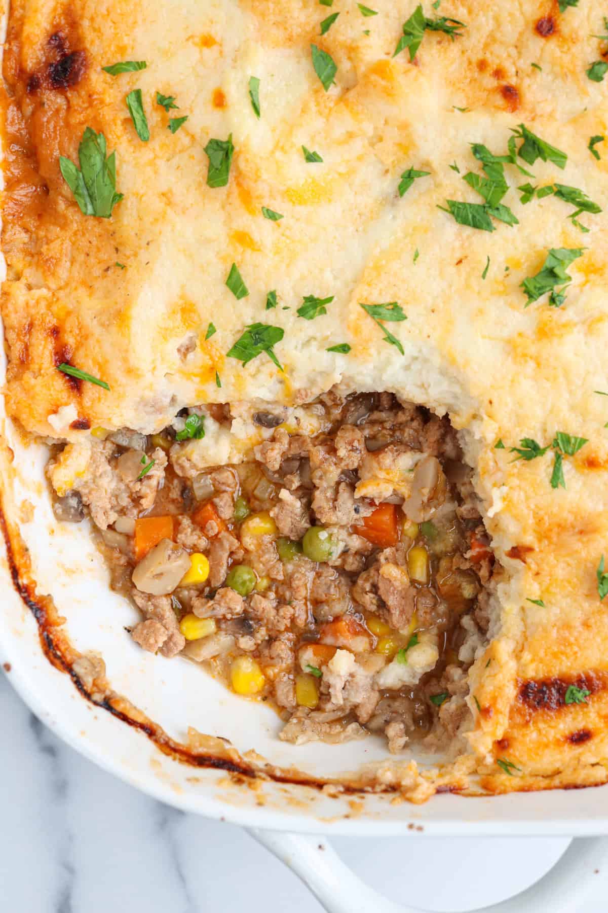 shepherd's pie with ground turkey in a white casserole dish.
