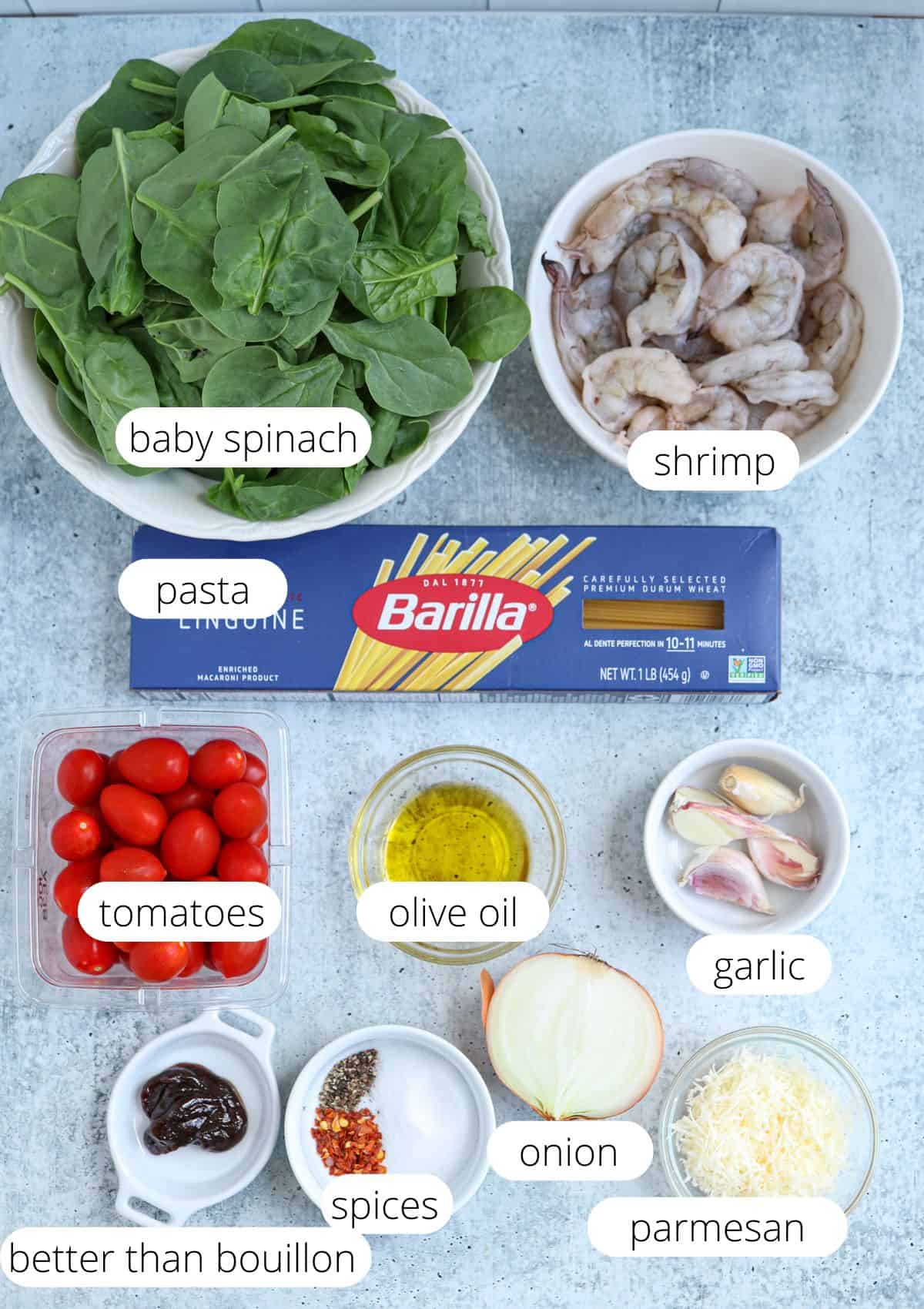 ingredients for making shrimp, spinach and tomato pasta with captions. 