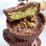 A stack of three chocolate cups with a pistachio filling, reminiscent of the rich green in pesto chicken parmesan, topped with chopped pistachios. The top cup is cut in half to reveal the vibrant green filling. Text above reads Dubai Chocolate Cups.